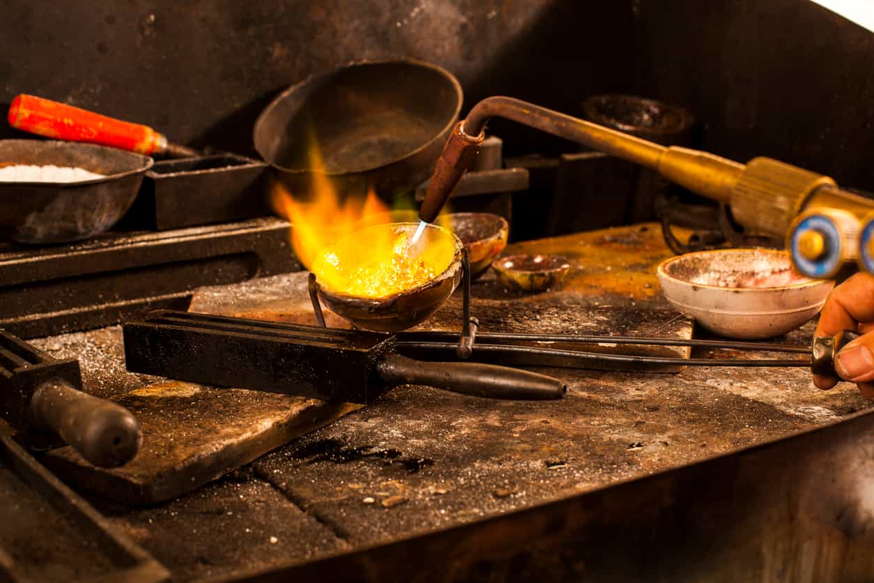 Gold slips to one-week low as safe-haven buying stalls, dollar strengthens