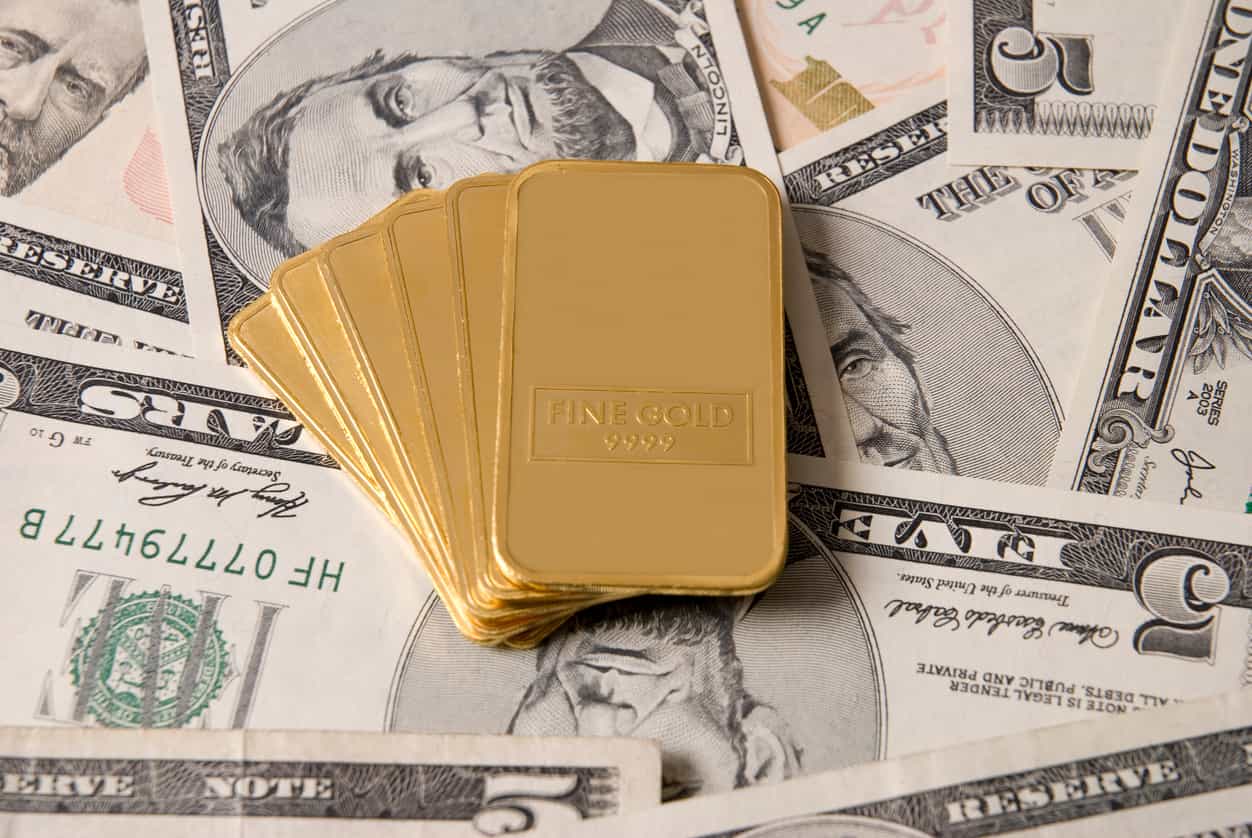 Gold falls on firmer dollar, dimming US rate cut hopes