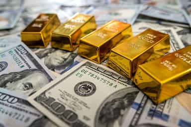 Gold pulls back after two-month high as oil, hawkish Fed outlook weigh