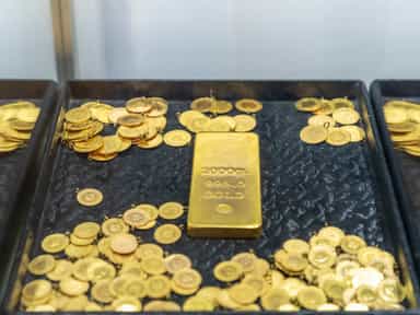 Gold firms on weaker dollar as markets await US inflation data