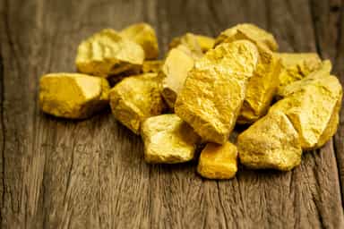 Gold edges up after hitting 2-month low as markets weigh Fed rate path
