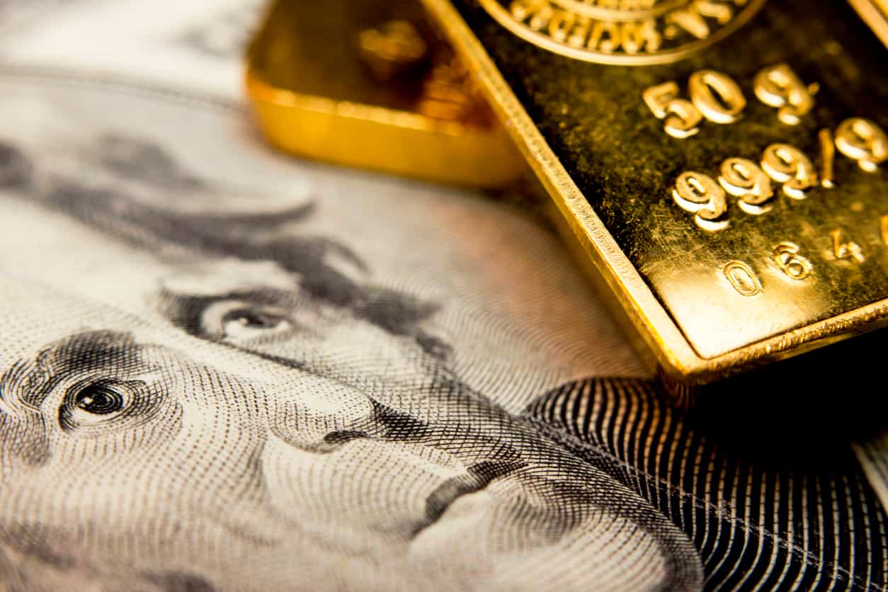 Gold edges lower on firmer dollar as investors await US economic data