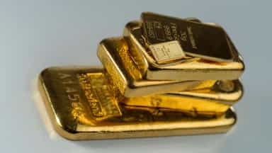 Gold prices slip as dollar firms, but Fed turmoil limits losses