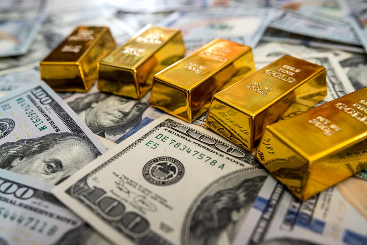 Gold pulls back after two-month high as oil, hawkish Fed outlook weigh