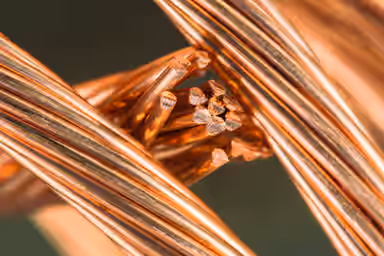 London copper dips on firmer dollar, but set for monthly gains